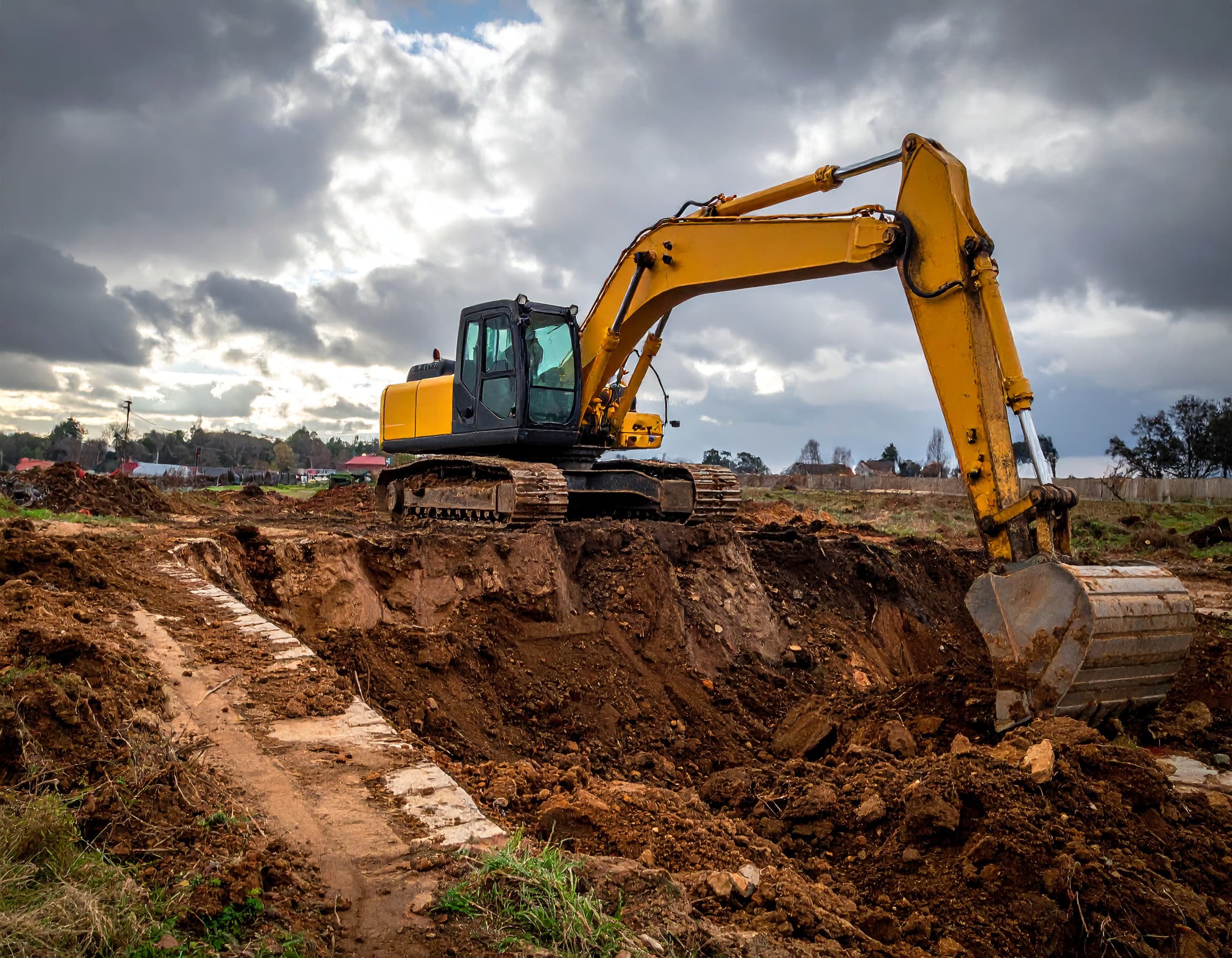 Commercial excavation equipment preparing an active construction site in Simcoe County