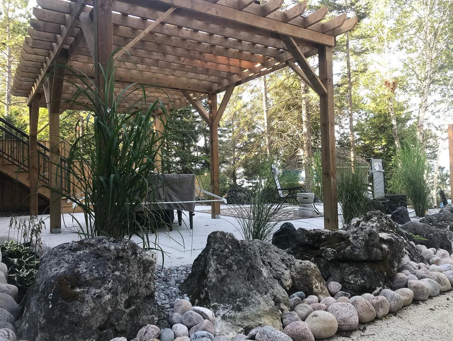 Sloped property hardscape landscape drainage integration Barrie Ontario
